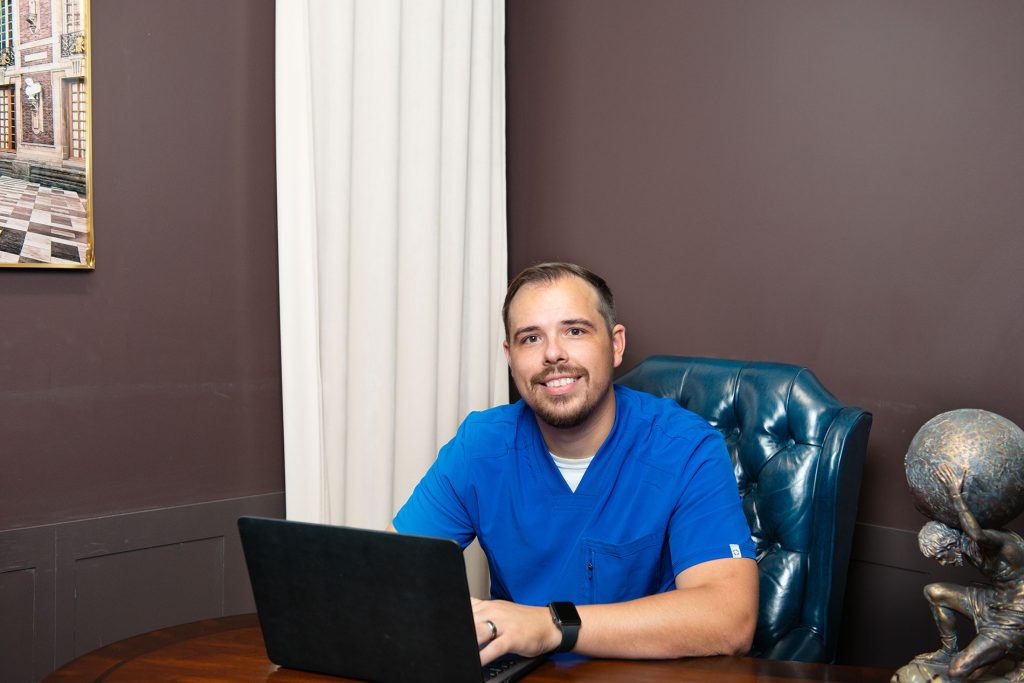 Dr. Kasey at Desk with online medicine consulting computer