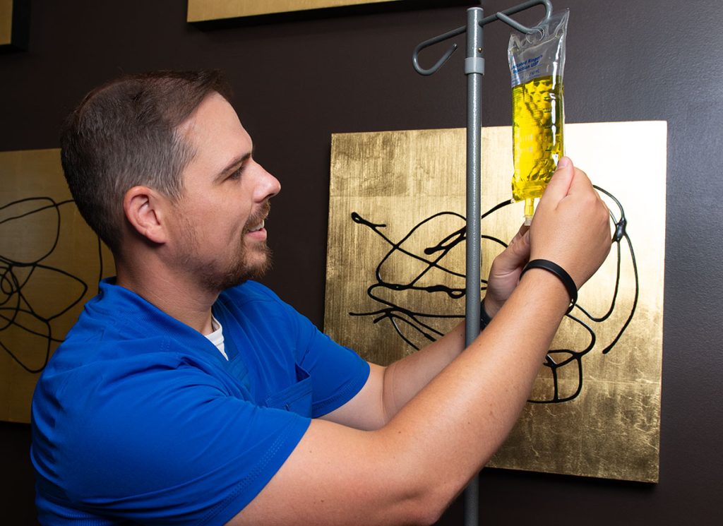 Dr Kasey Hanging an IV Bag