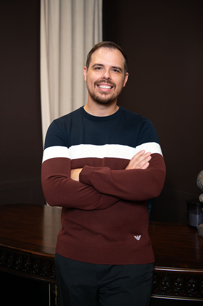 Dr Kasey in the office with arms crossed.