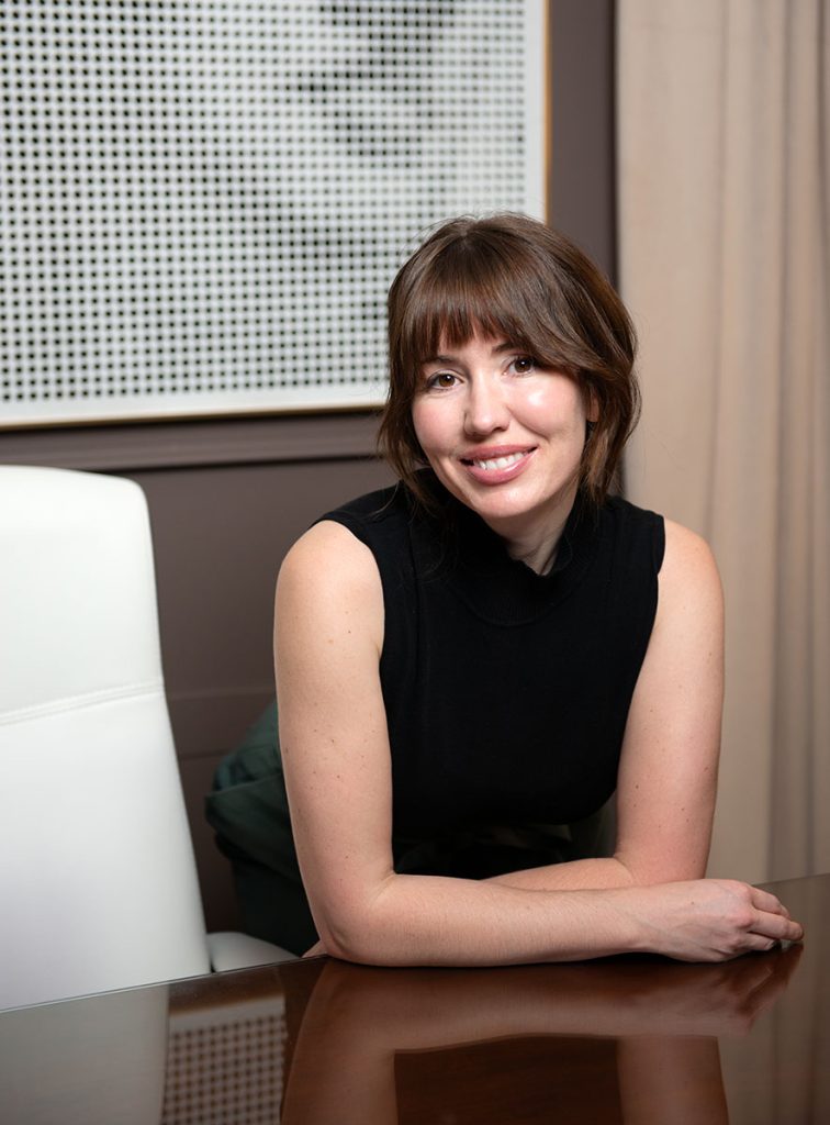 Dr Stephanie sitting at desk consulting with patients