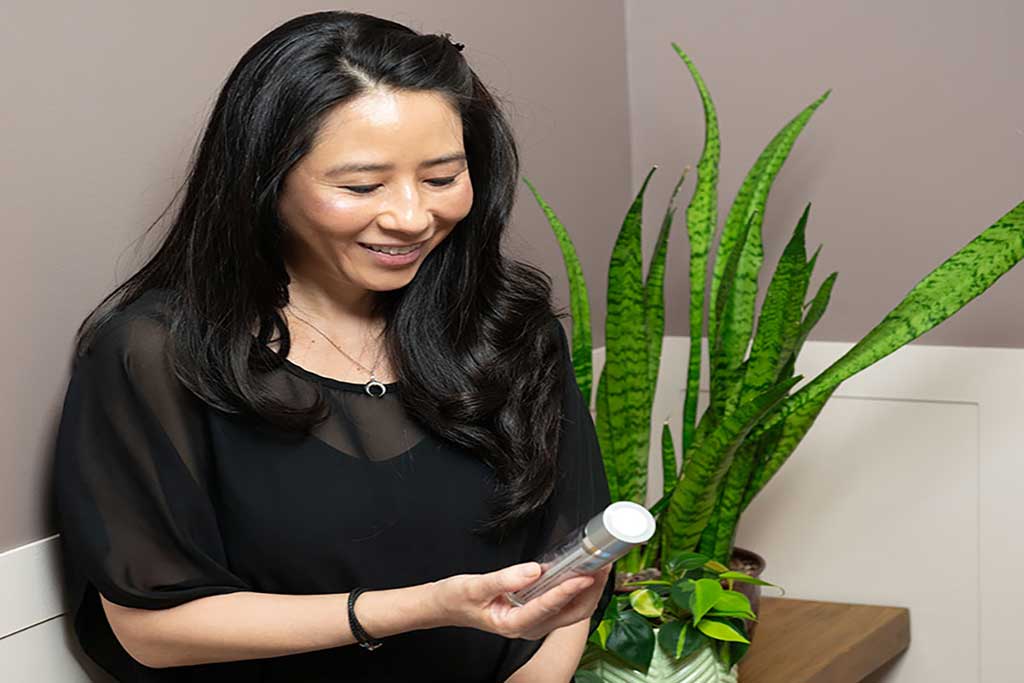 Woman reviewing her skin care products from Onyx.