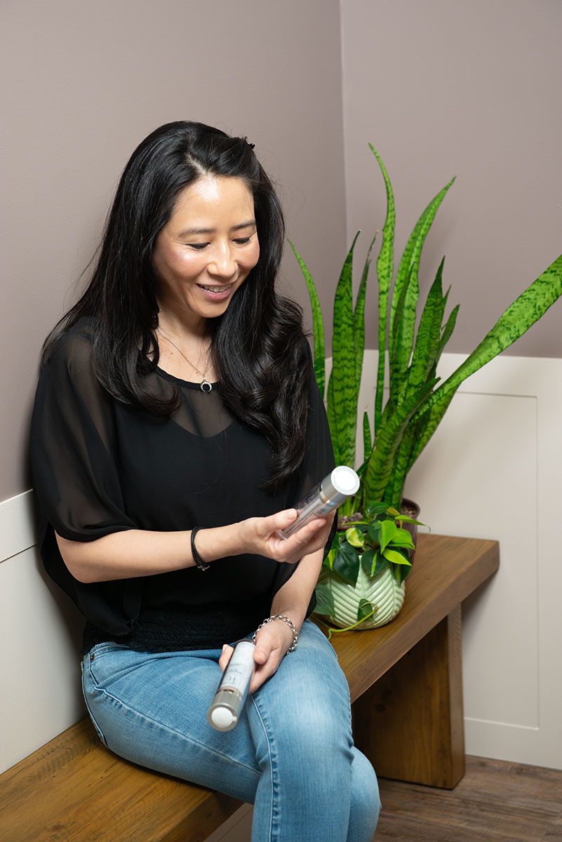 Woman looking at skin care products.