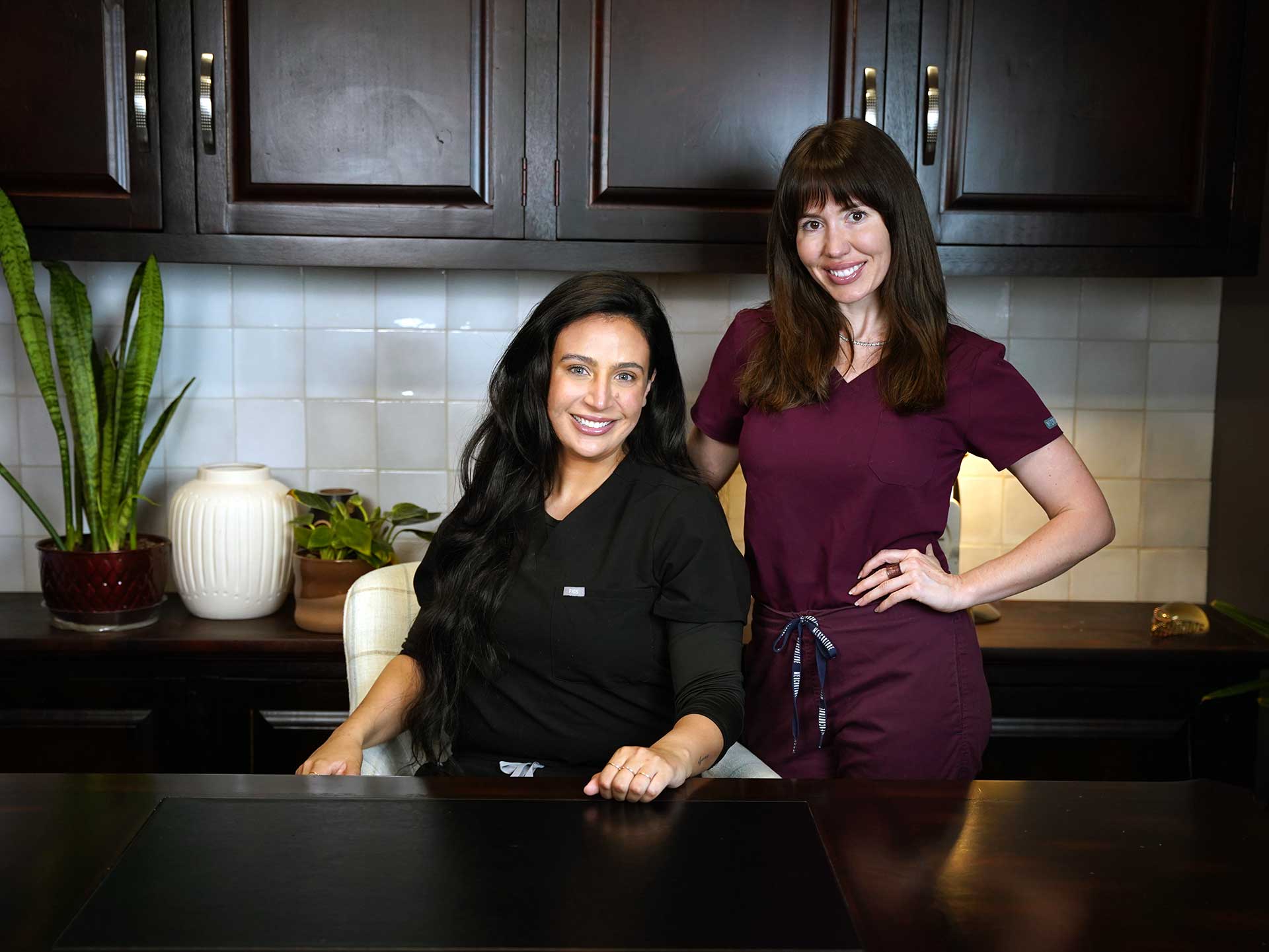2 naturopathic doctors in Gilbert, Arizona standing at desk.